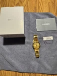 Title: Seiko 5 SNKK98K1 21-JEWEL Automatic Gold Dial 38MM Box & Papers. Fixed Price $190.00.